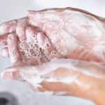 Hands being washed to reduce bacteria