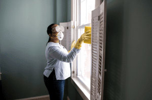 Lady disinfecting & cleaning her windows