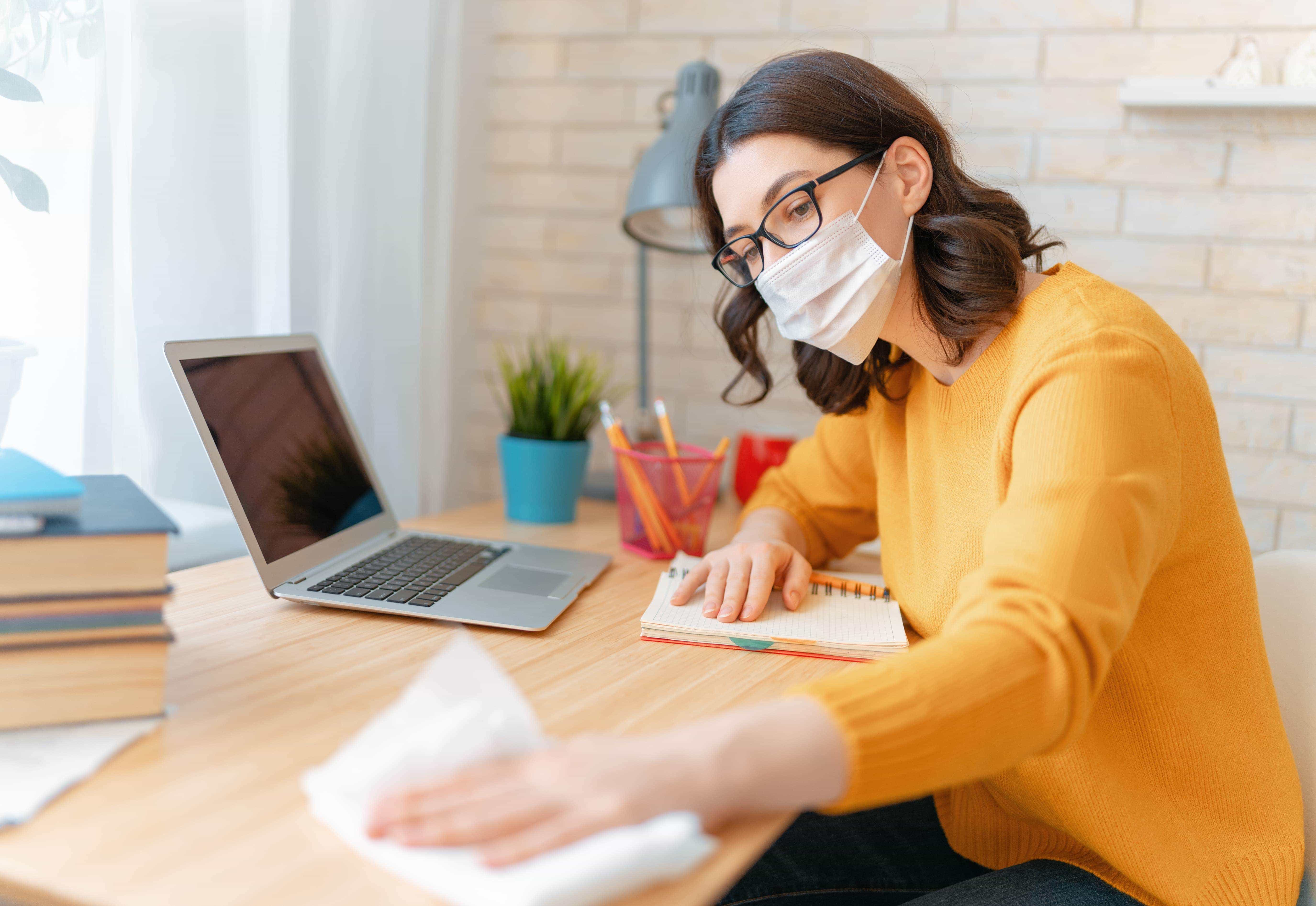 Employee cleaning her workplace