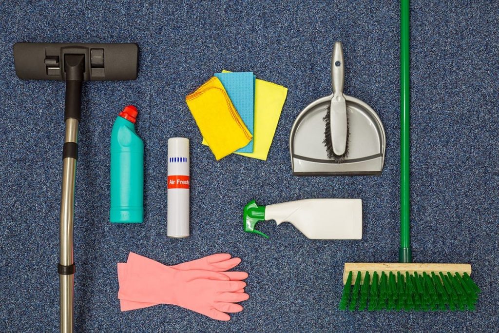 Range of commercial cleaning supplies spread across the floor