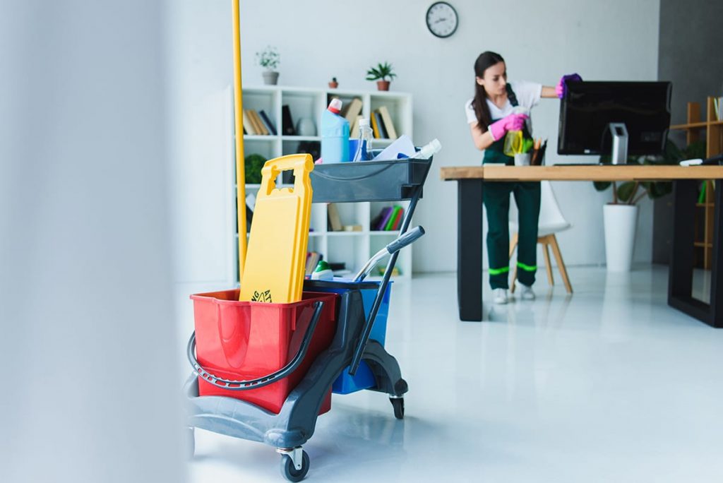 Jani-King commercial cleaner cleaning an office workplace
