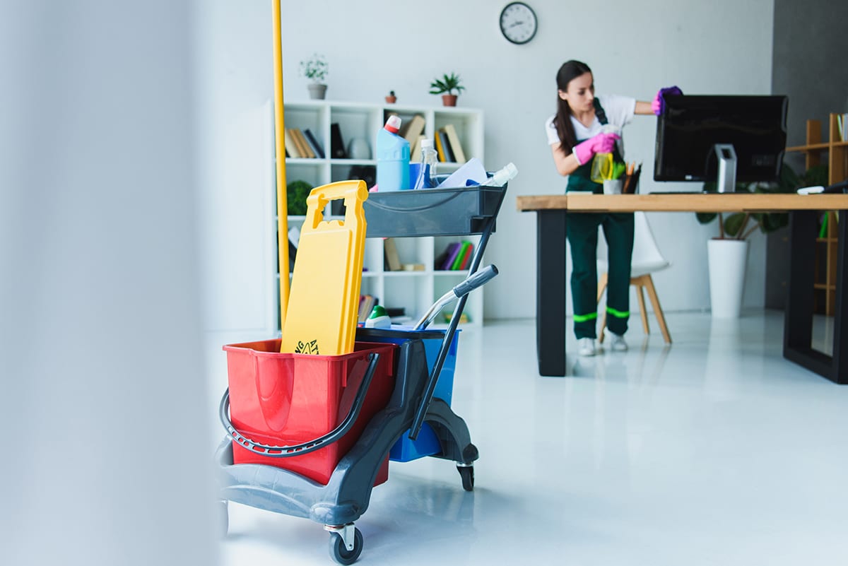 Jani-King commercial cleaner cleaning an office workplace