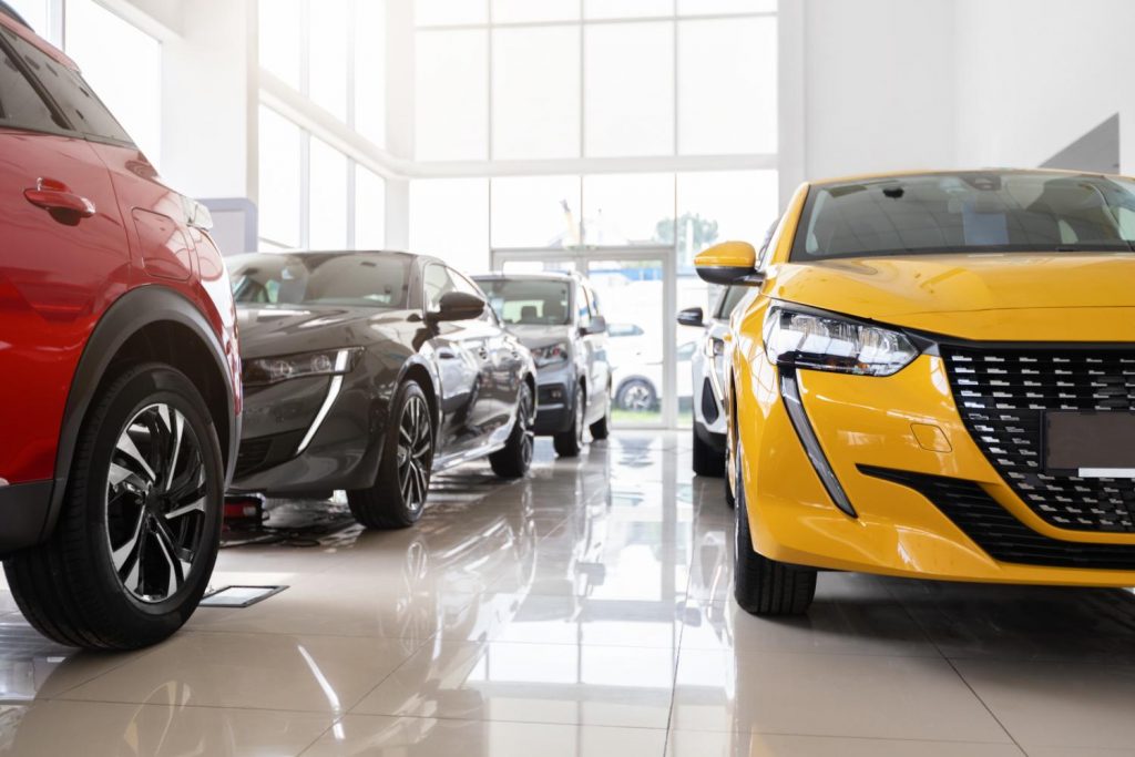 red yellow and black cars at a clean car dealership